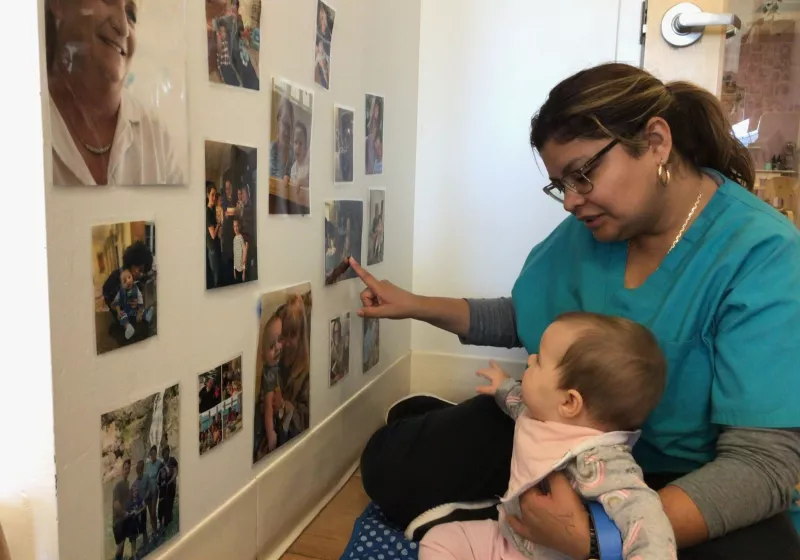 Infant observing the pictures on the wall