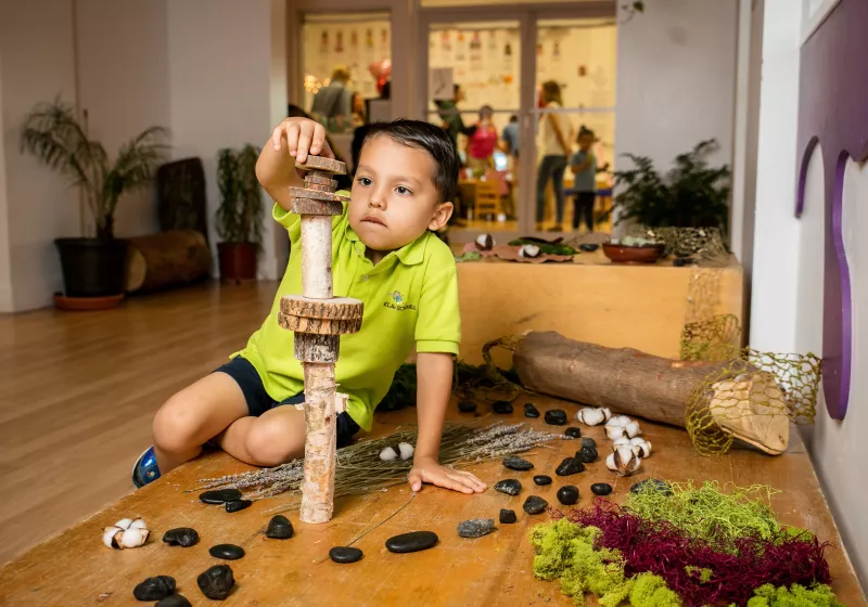 a student at our preschool stacking wooden pieces
