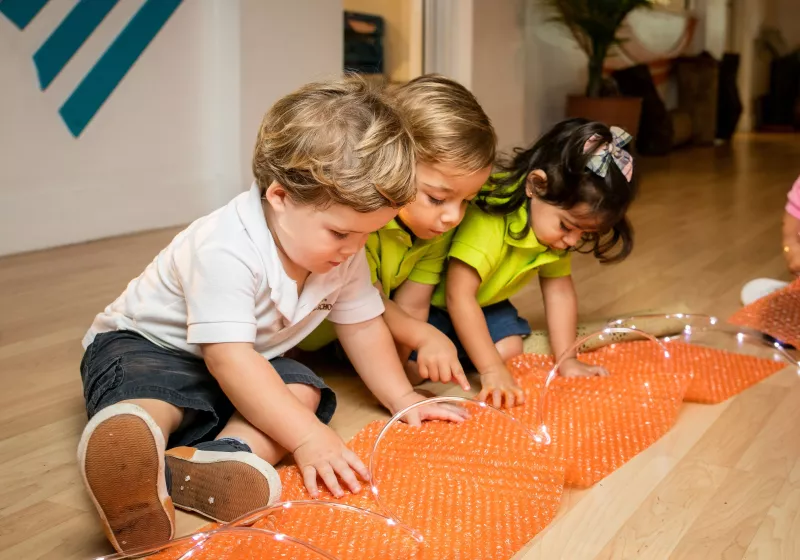 children engaged in sensory play in our daycare