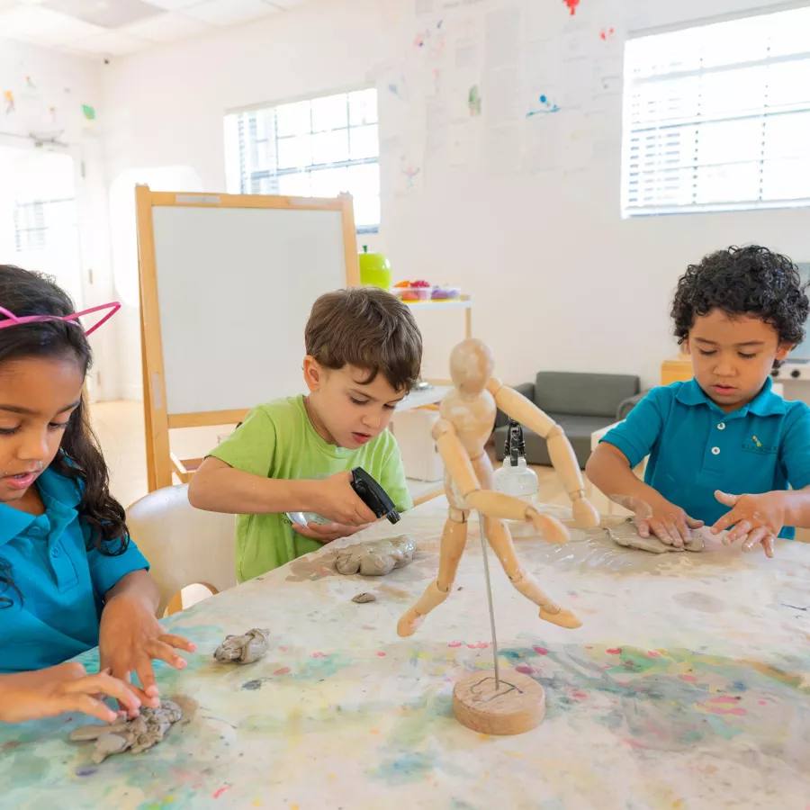 three students using art materials in our after school care