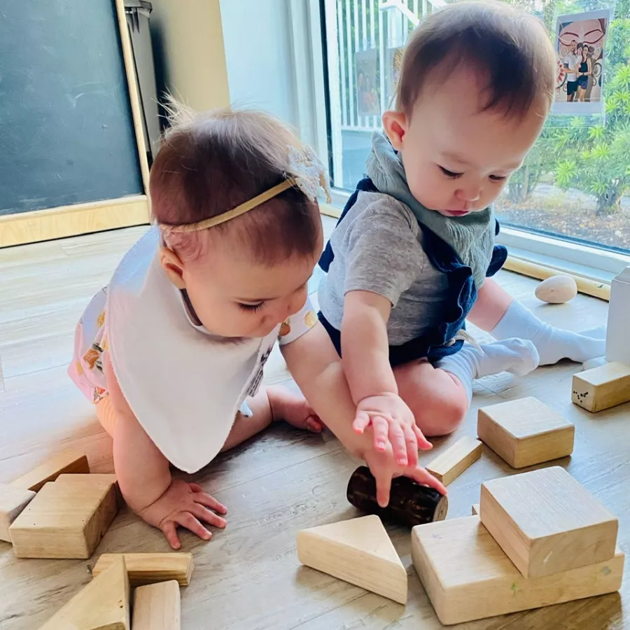 2 babies playing with blocks at our daycare for infants