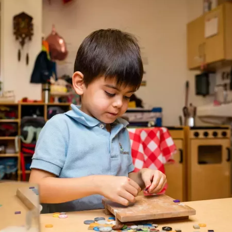 a boy playing learning to count by playing at our childcare for 3 year olds