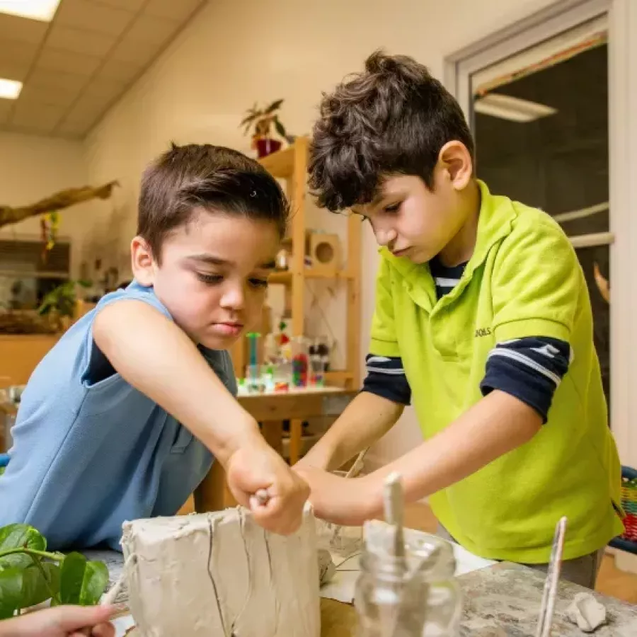two students doing clay art in our before and after school care