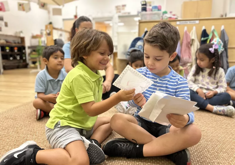 classroom engaged in reviewing letters at our Doral daycare