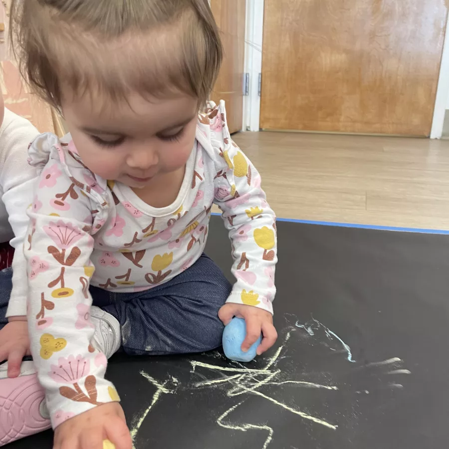 KLA Schools child with chalk