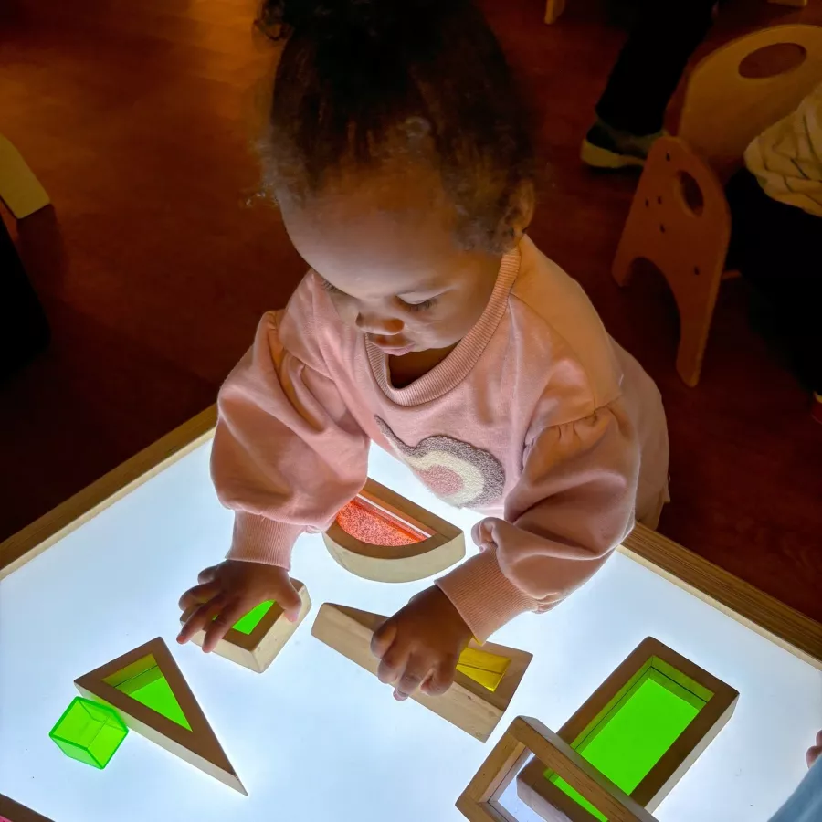 child playing on light table at our Bellevue daycare