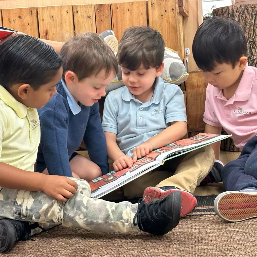 Children reading books together at our Doral daycare