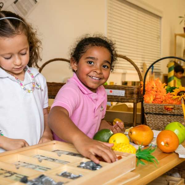two students feeling textures in our preschool curriculum