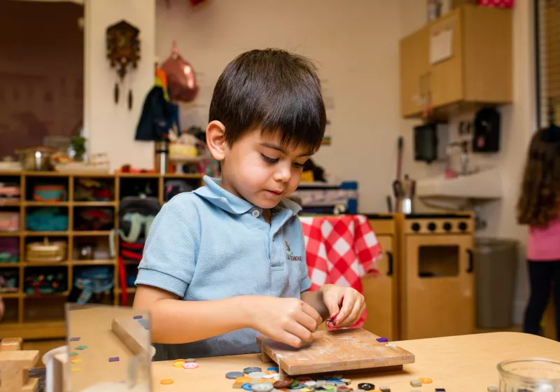 Preschool boy counting playing