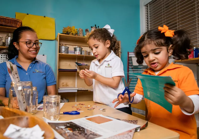 Preschool teacher girls paper art