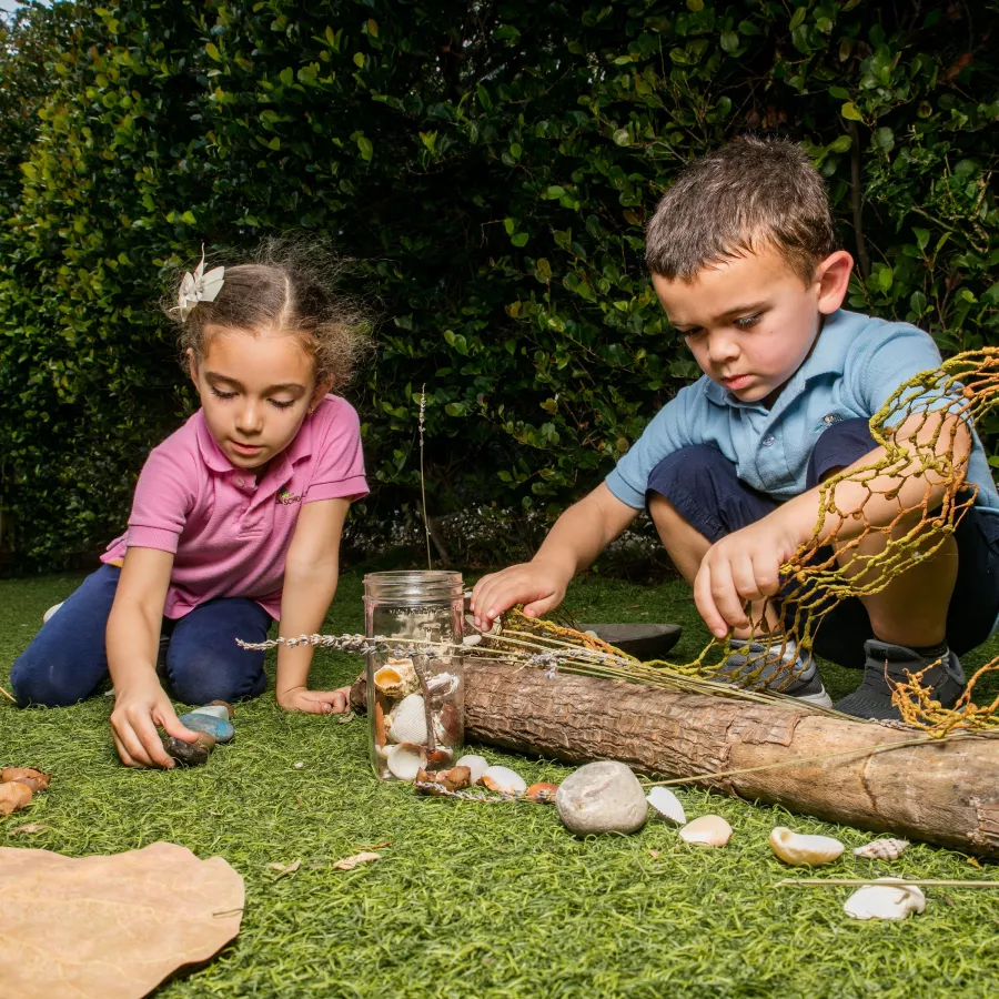 Preschool girl boy playing in nature outside