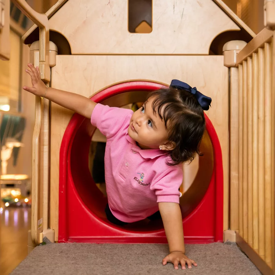 Preschool girl playing indoor playground
