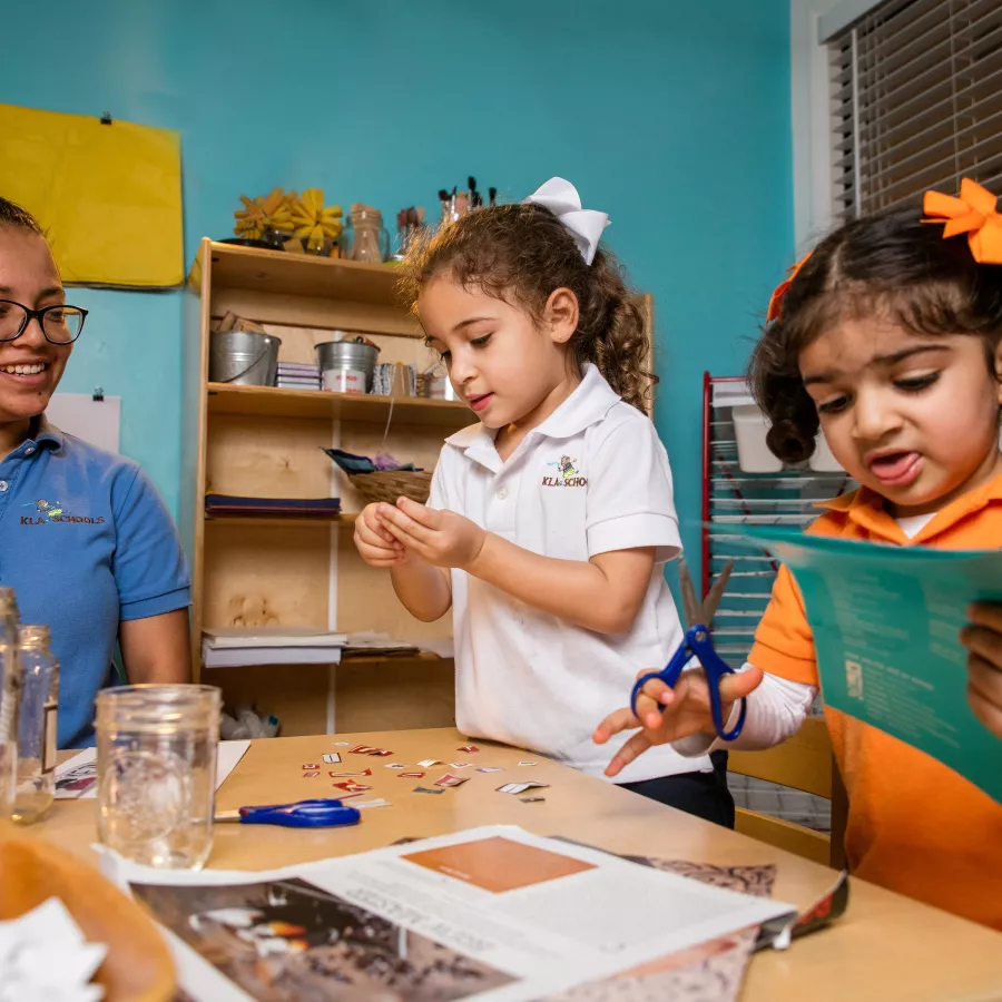 Preschool teacher girls paper art