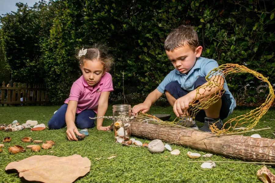 Preschool girl boy playing in nature outside