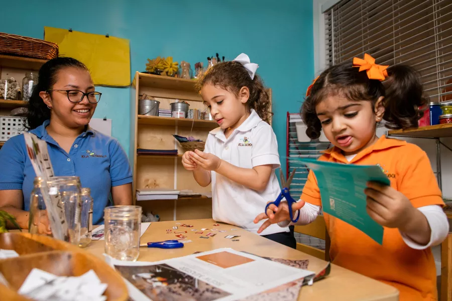 Preschool teacher girls paper art