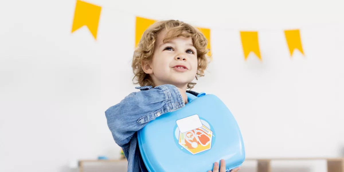 Front view happy boy holding kit