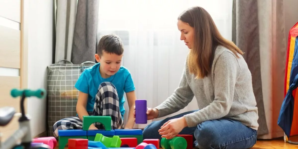 Young mother her son playing together with colorful blocks 416256 3001