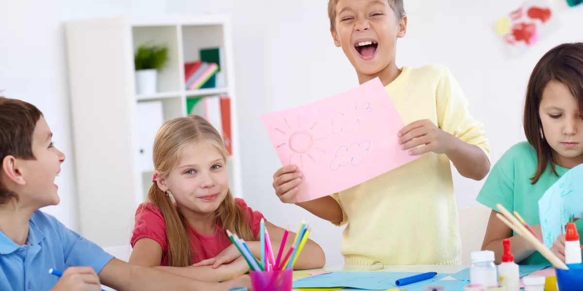 Glad boy showing his artwork