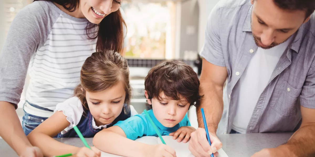 Family writing book while standing table 1