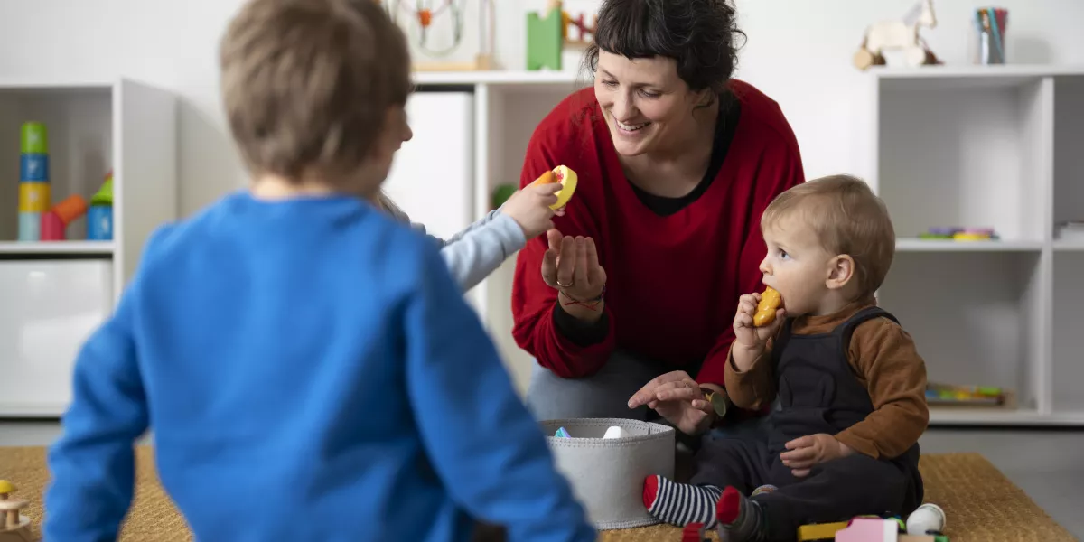 Teacher helping kids learn montessori method