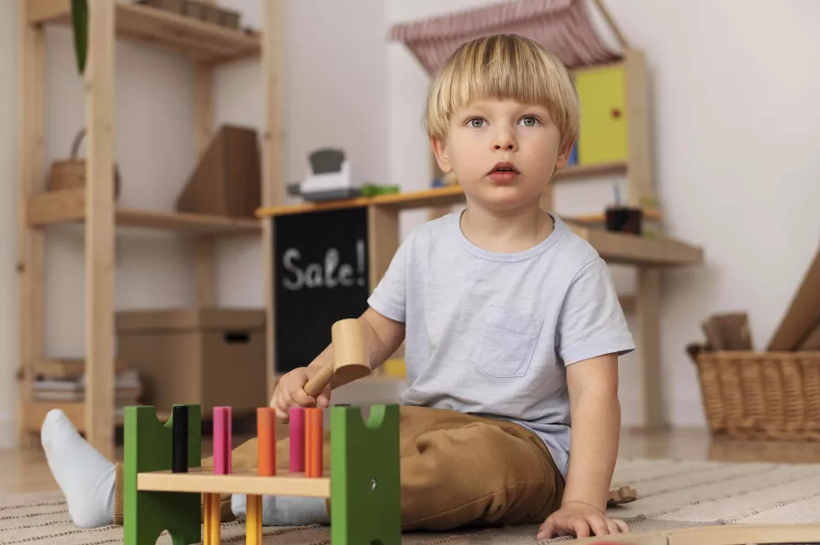 Adorable kid playing with toy full shot min