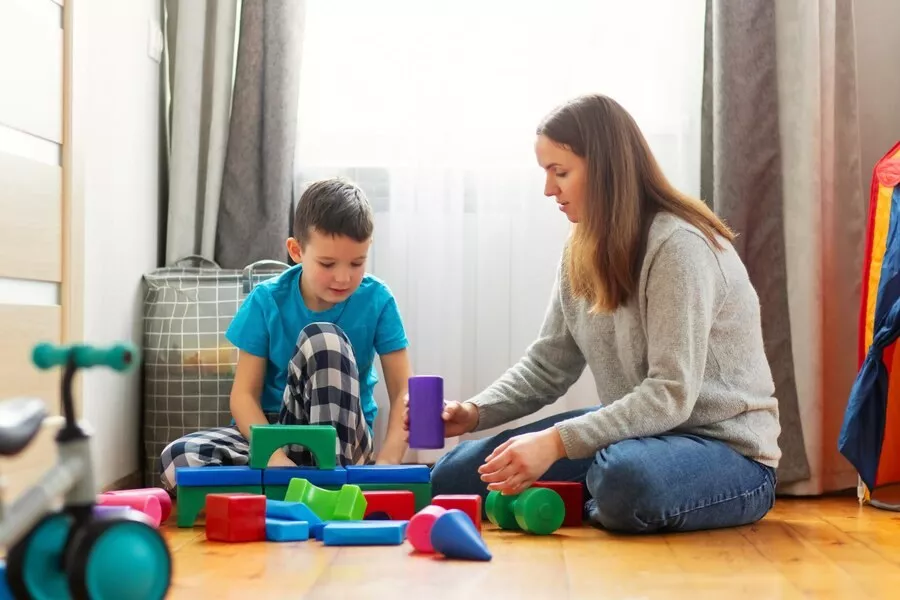 Young mother her son playing together with colorful blocks 416256 3001