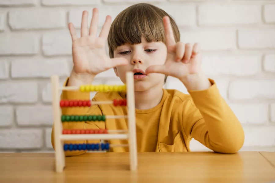 Front view child using abacus learn how count
