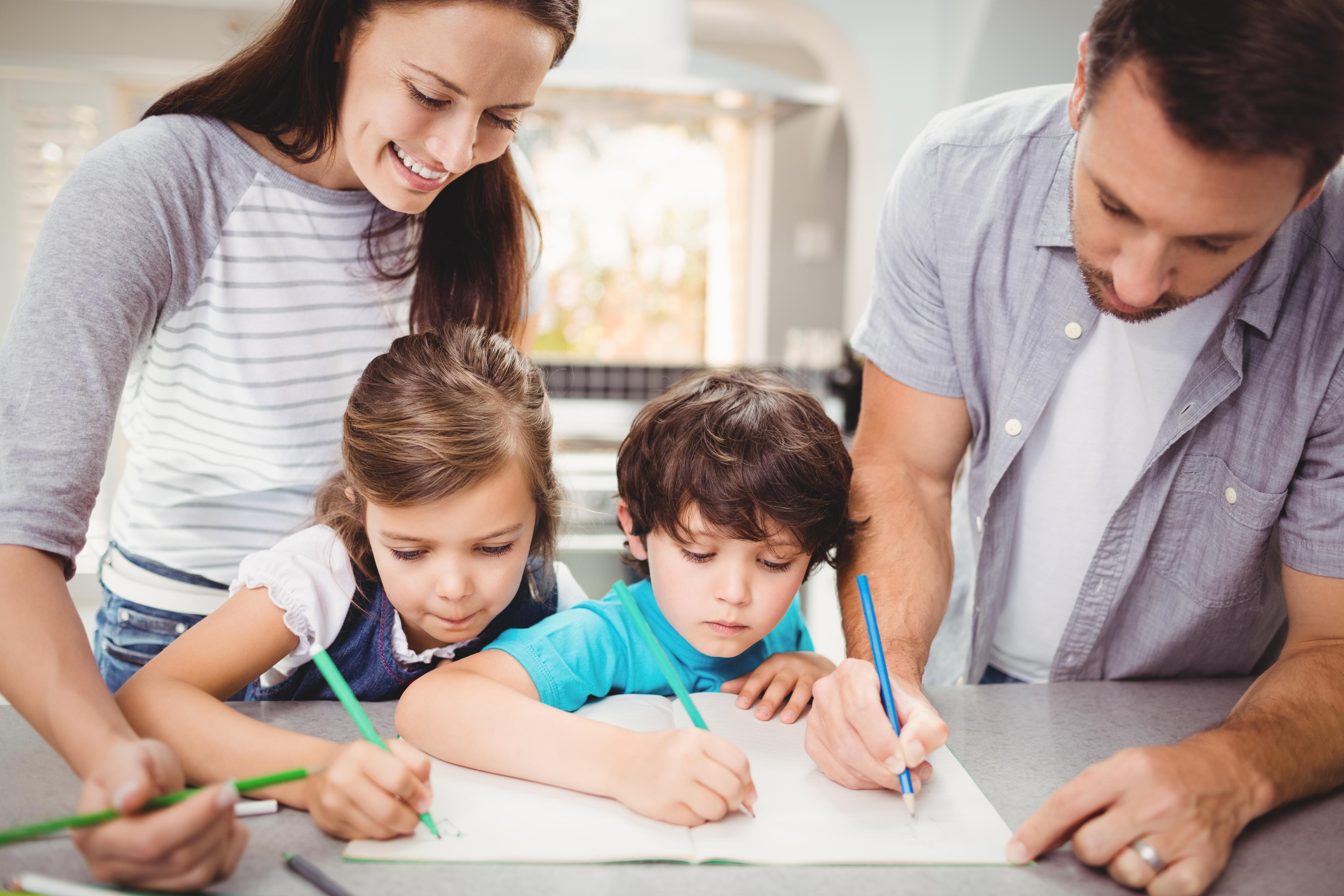 Family writing book while standing table 1