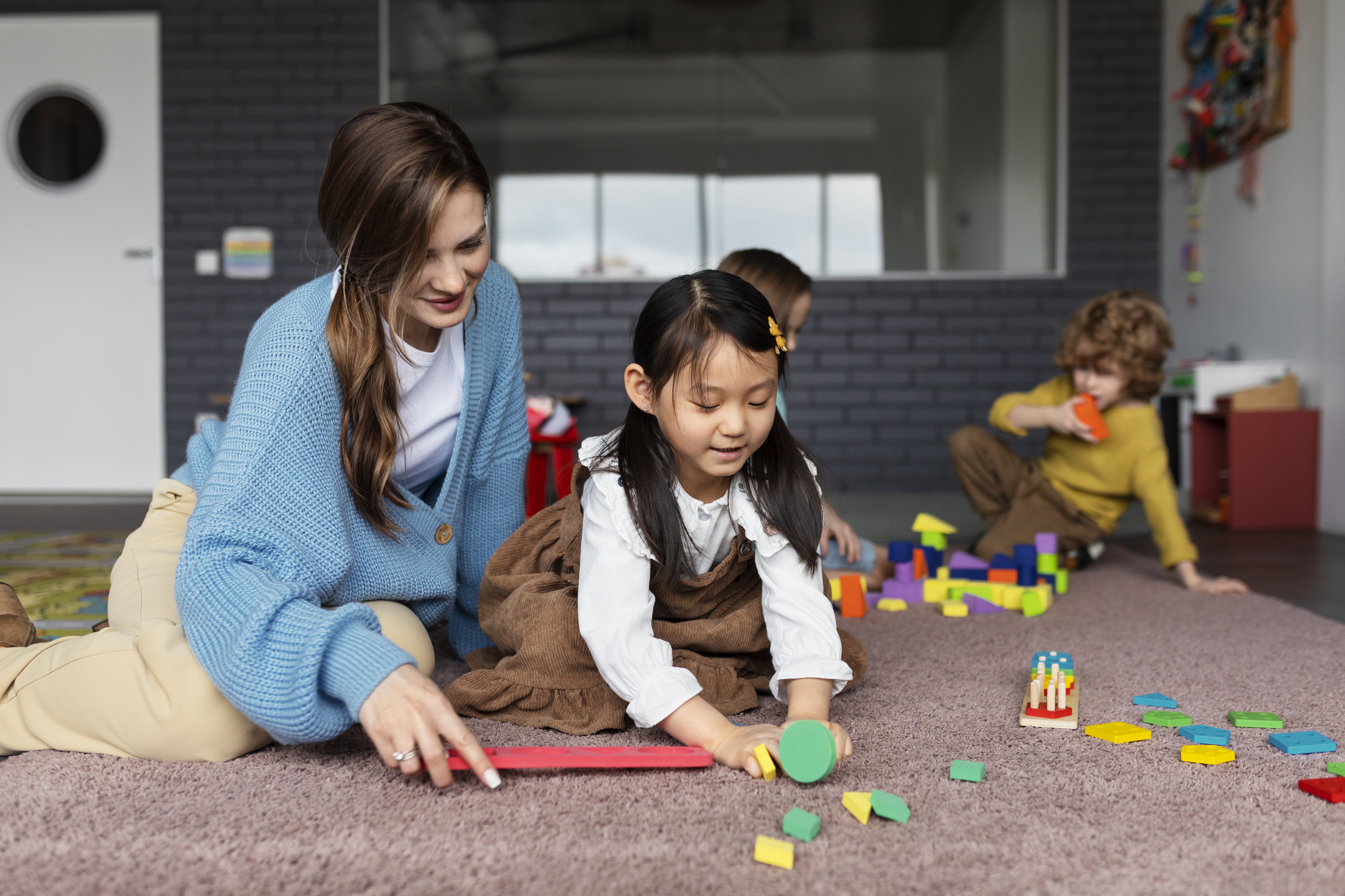 Full shot smiley teacher helping girl learn