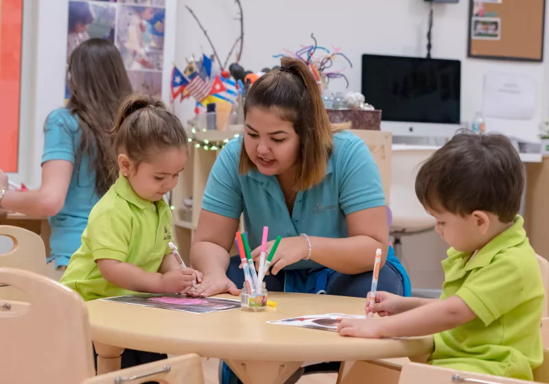 Preschool students working on project with teacher