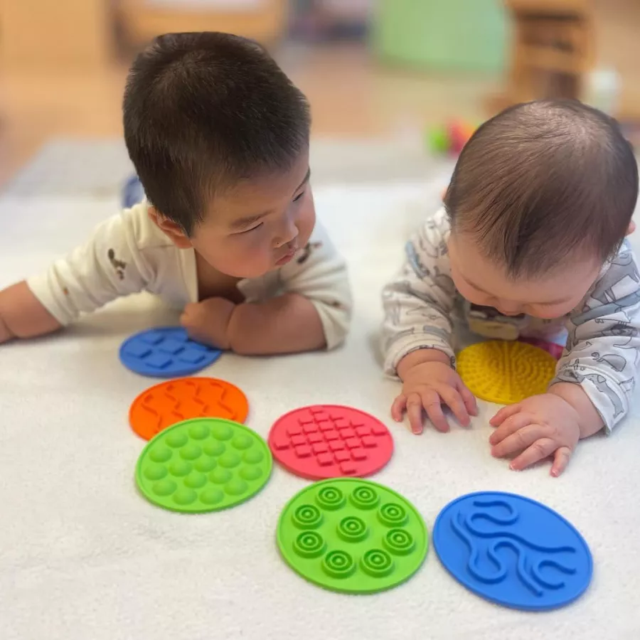 two infants exploring textures at our daycare in bellevue wa