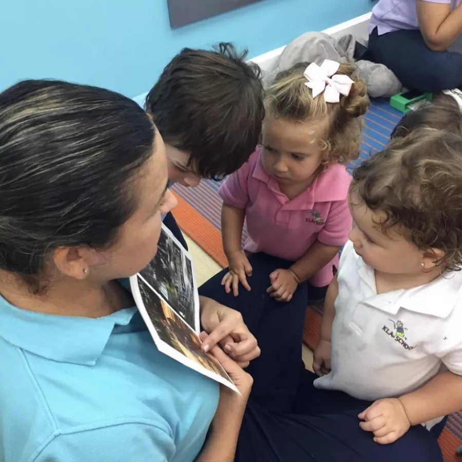 a group of children looking at pictures at our daycare in doral fl