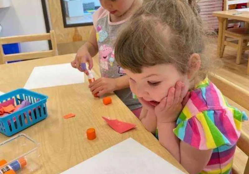 preschool girl doing a collaborative project with other students