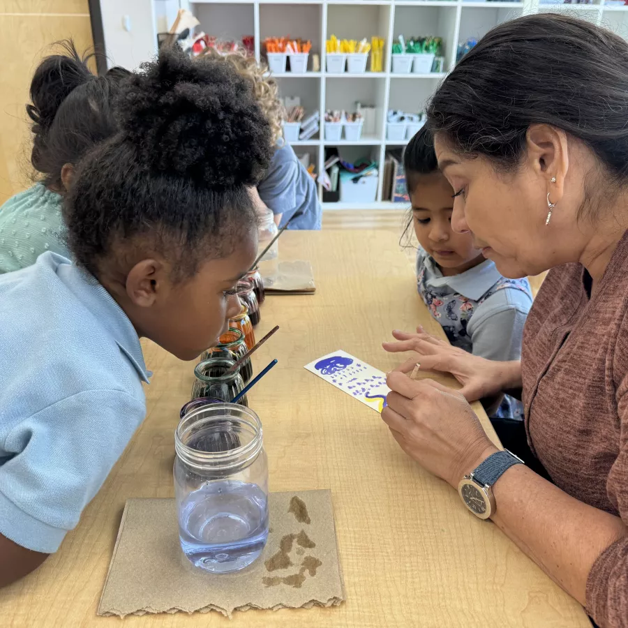 Children with teacher painting project
