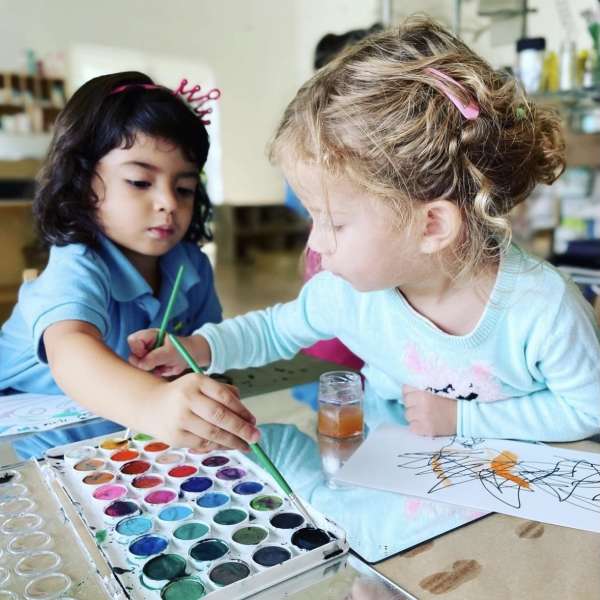 two students coloring in our private preschool