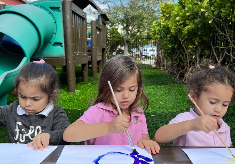 Girls drawing outside