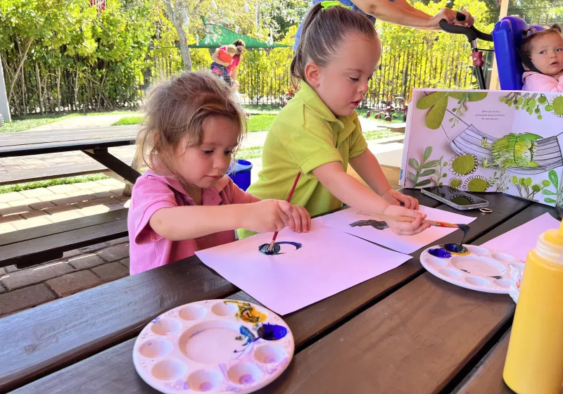 girls drawing outside