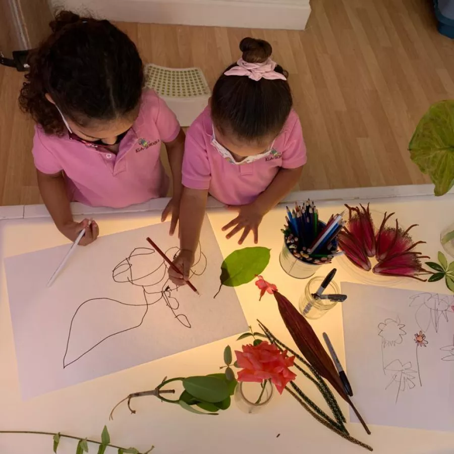 Girls with light table drawing plants