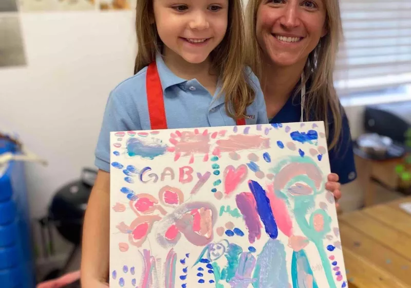 Girl displaying her art