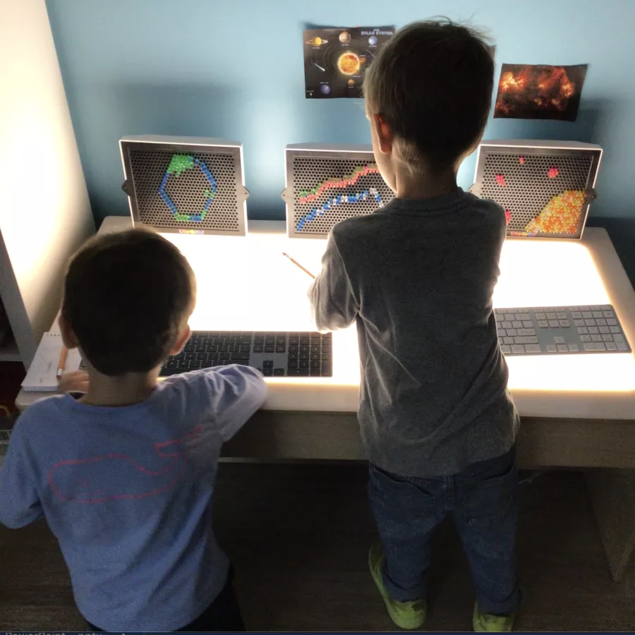 two students exploring keyboards in our daycare